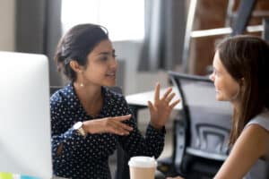 Women leaders in the energy sector discussing innovative policies over coffee