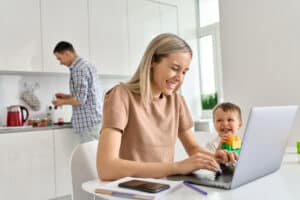 Woman working from home with child